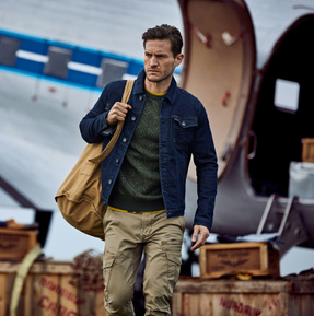 Man with blue denim jacket and green cargo pants