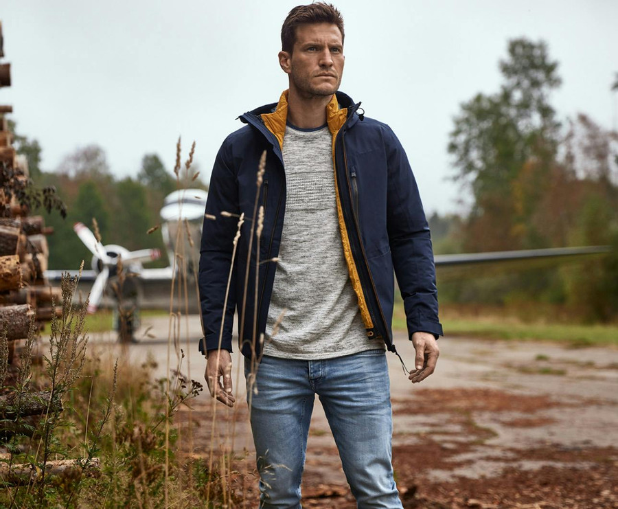 Man with blue PME Legend jacket, gray sweater and blue Commander jeans